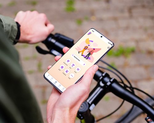 mockuuups-holding-bike-in-one-hand-with-samsung-s20-mockup-in-the-other
